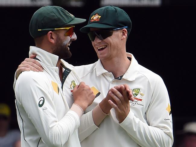 Peter Handscomb (R) shares a joke with Nathan Lyon at the Gabba.