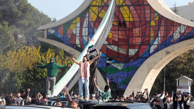 People in Damascus celebrate the rebels’ victory. Picture: AFP.