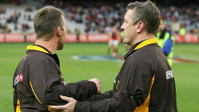 Alastair Clarkson is held back by Hawthorn official Mark Evans after a fiery Hawks-Bombers clash.