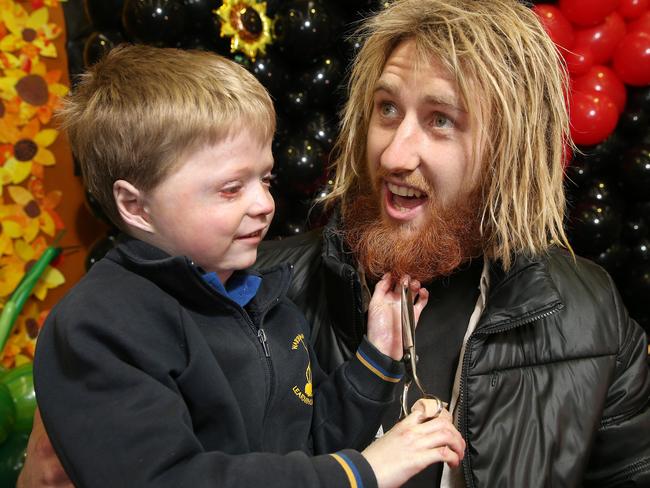 Harrison Pennicott with his hero, Essendon skipper Dyson Heppell, at his huge Get Behind The Beard fundraiser in June. Picture: Michael Klein