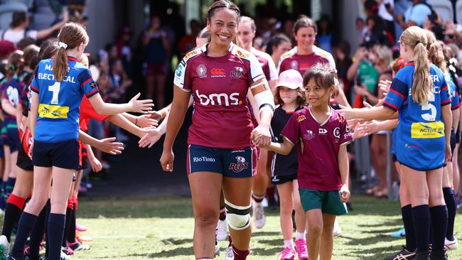 BRISBANE, AUSTRALIA - MARCH 17: Cecilia Smith of the Reds runs of with daughter Ruby during the round one Super Rugby Women's match between Queensland Reds and Fijian Drua at Ballymore Stadium on March 17, 2024 in Brisbane, Australia. (Photo by Chris Hyde/Getty Images)