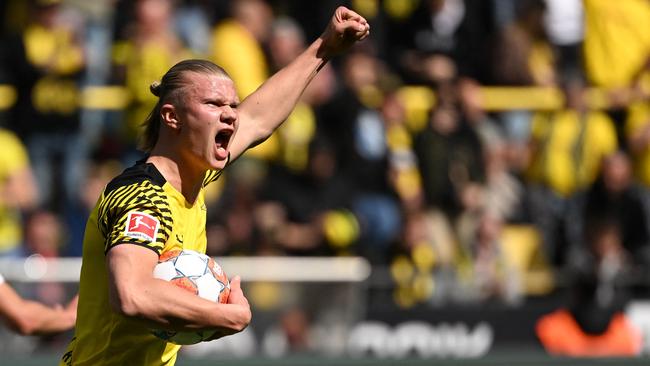 Dortmund's Norwegian forward Erling Braut Haaland (L) celebrates after shooting from the penalty spot to score his team's first goal 1:2 during the German first division Bundesliga football match between Borussia Dortmund and VfL Bochum in Dortmund, western Germany on April 30, 2022. (Photo by INA FASSBENDER / AFP) / DFL REGULATIONS PROHIBIT ANY USE OF PHOTOGRAPHS AS IMAGE SEQUENCES AND/OR QUASI-VIDEO