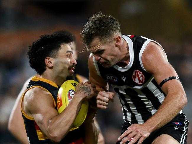 ADELAIDE, AUSTRALIA - AUGUST 17:   Izak Rankine of the Crows is knocked out by  a late hit from  Dan Houston of the Power during the round 23 AFL match between Port Adelaide Power and Adelaide Crows at Adelaide Oval, on August 17, 2024, in Adelaide, Australia. (Photo by Mark Brake/Getty Images)