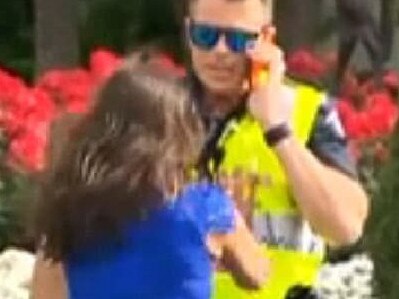 The woman in the blue dress made headlines for confronting a police officer.