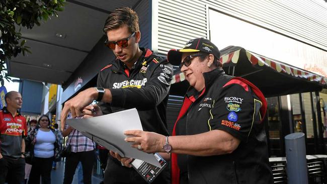 Chaz Mostert signs a poster for Anna Millington at the Supercars fan day. Picture: Rob Williams