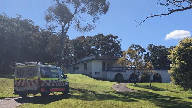 An ambulance arrives at the property. Paramedics treated a probationary police officer for facial injuries. Picture: Jim O'Rourke