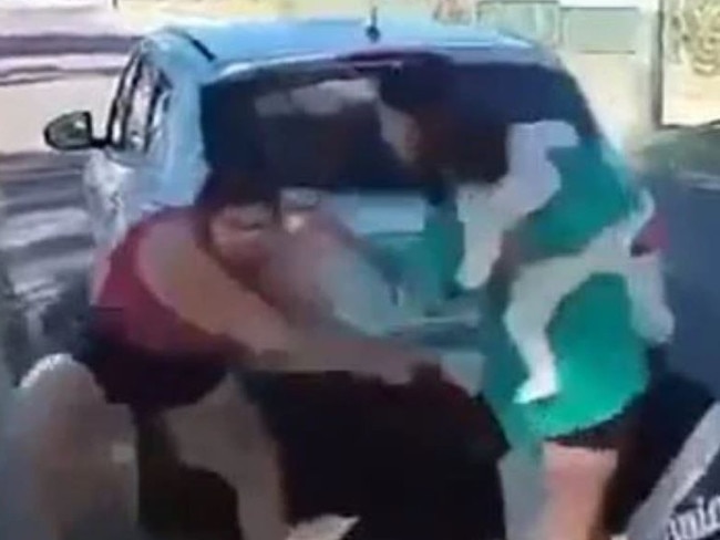A mother steps in to break up a wild fight between two women throwing punches and pulling hair in outback Queensland. Picture: Supplied
