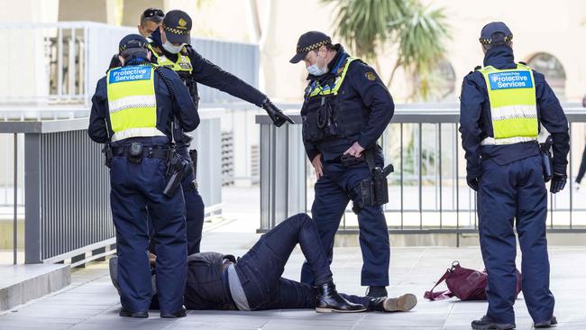 PSO officers surround the man. Picture: NCA NewsWire/Wayne Taylor