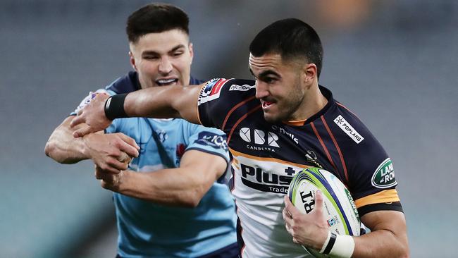 Brumbies winger Tom Wright evades the tackle of NSW’s Jack Maddocks in a Super Rugby AU match last month. Picture: Getty Images