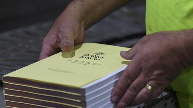 A worker handles copies of the 2018-19 Budget papers at Canprint in Canberra.