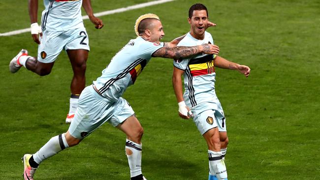 Eden Hazard (R) of Belgium celebrates scoring his team's third goal.