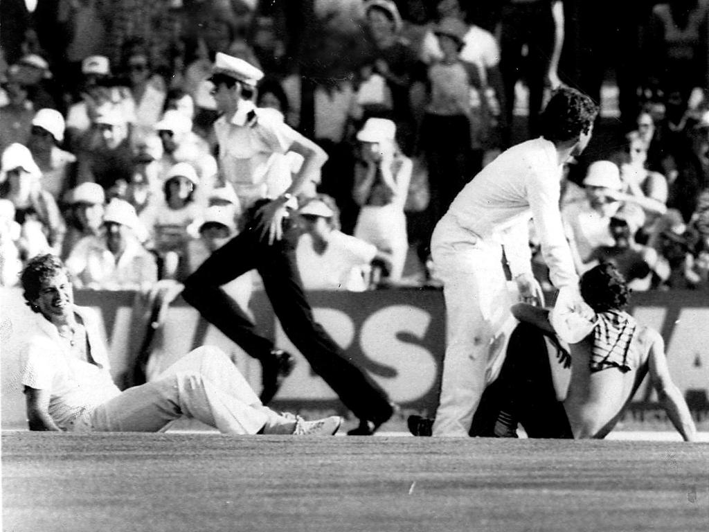 Terry Alderman grimaces in agony on ground after he dislocated his shoulder when he chased pitch invader who slapped him during Australia v England test at WACA in Perth in 1982.