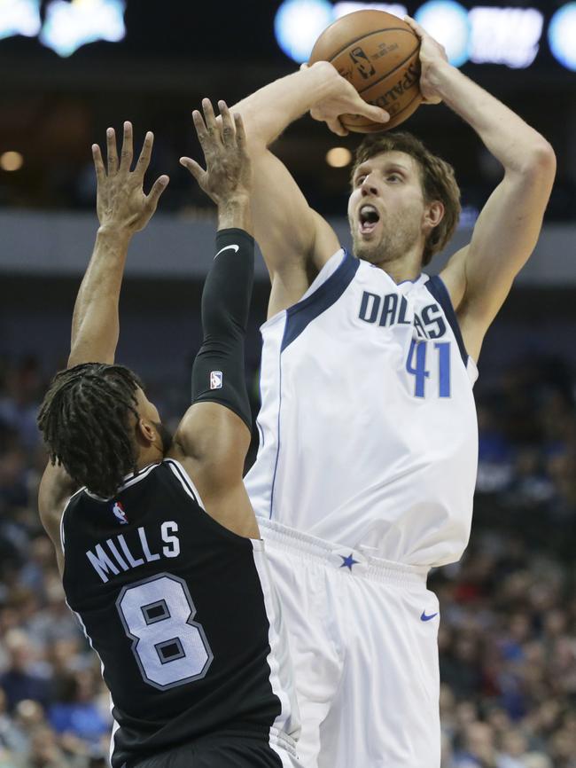 Dirk Nowitzki drains one over Aussie Patty Mills. The German is Dallas’ greatest player and Ronzone was part of the team that brought him to Texas. Picture: AP