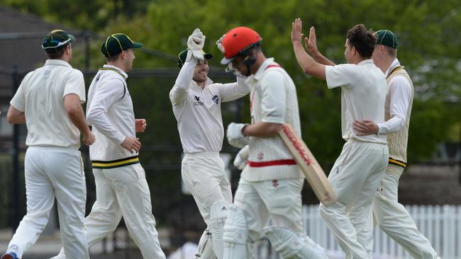 Camberwell Magpies players celebrate after taking the wicket of Lachlan Sperling. Picture: Chris Eastman