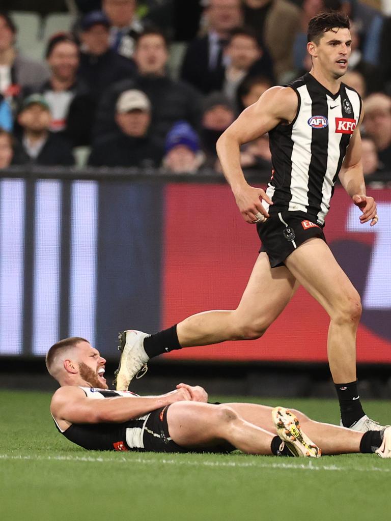 Taylor Adams fell to the ground in pain late against the Cats. Picture: Michael Klein