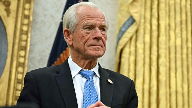 Counselor to US President Donald Trump, Peter Navarro listens to unseen US President Donald Trump speak to the press after signing an executive order, in the Oval Office of the White House in Washington, DC, on February 10, 2025. (Photo by ANDREW CABALLERO-REYNOLDS / AFP)