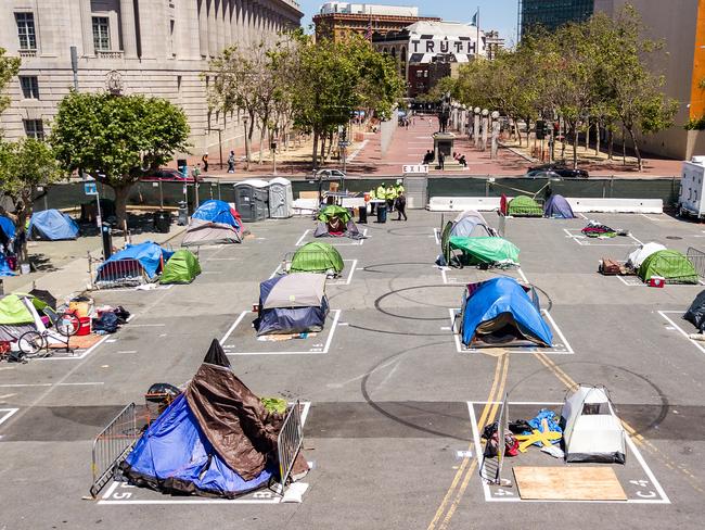 Rectangles are painted on the ground to encourage homeless people to keep social distancing at a city-sanctioned homeless encampment in San Francisco. Picture: AFP