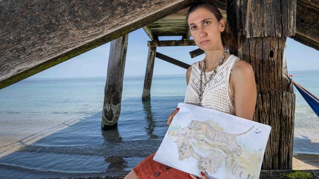 Kendehl, the daughter of Roman Heinze, with one of his drawings. Picture: Ben Clark