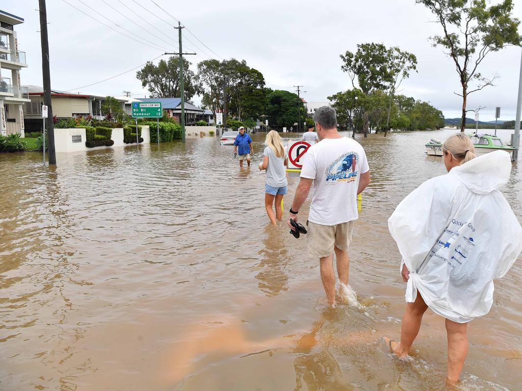 Bradman Ave, Maroochydore residents walk through floodwaters. Picture: Patrick Woods.