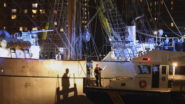 A New York Police Department harbour unit prepares to board the masted Mexican Navy training ship that collided with the Brooklyn Bridge. Picture: AP