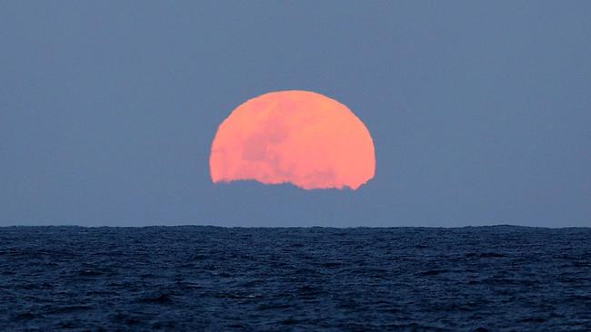 A smaller supermoon is seen from A Sydney beach last September. Picture: Getty Images.