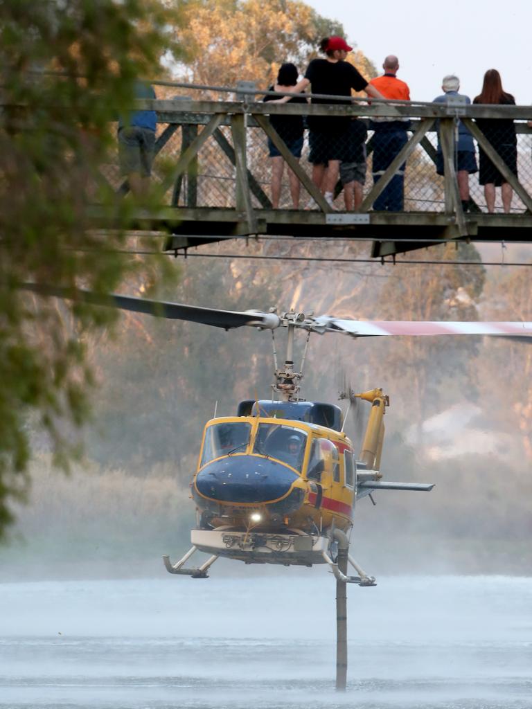 A helicopter gathers more water to fight fires in the Lockyer Valley. Picture: Steve Pohlner