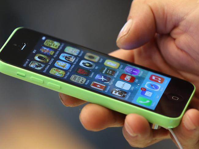 Splash of colour ... A customer tries out the new Apple iPhone 5C smartphone on the first day of sales in 2013. Picture: Getty Images