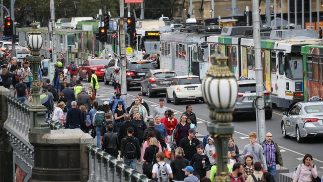 Pedestrians at Princes Bridge in Melbourne's CBD during rush hour. Picture: Ian Currie