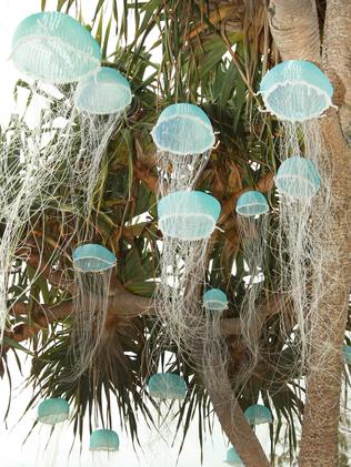 Crowds and People looking at art at the Swell sculpture festival held on Currumbin Beach . art by Melissa Hirsch called Jellyfish Tree . Picture Mike Batterham