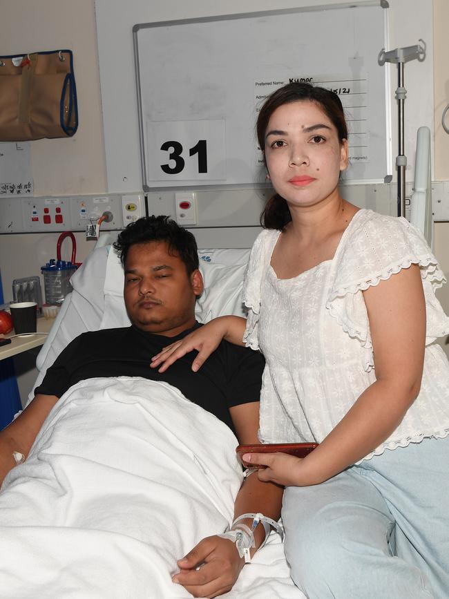 Kumar Dangi recovers in Royal Darwin Hospital on Tuesday with his wife Kalpana Giri by his side. Picture: Katrina Bridgeford.