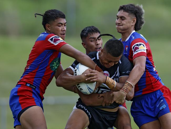 Maxwell Taotua is met by a wall of defenders. Picture: Michael Gorton