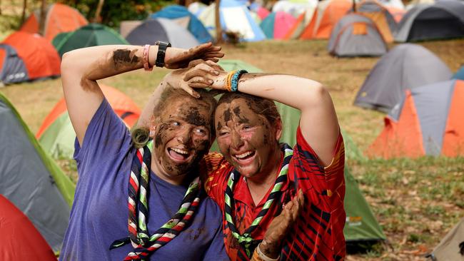 Big wet: Venturer scouts Kimberley Stephens from Barnehurst, UK, and Julia Bugden of Flagstaff Hill became muddied friends. They along with more than 1200 scouts, who have gathered in SA for the 12-day adventure, are happy to be braving the conditions ahead. Picture: Dylan Coker