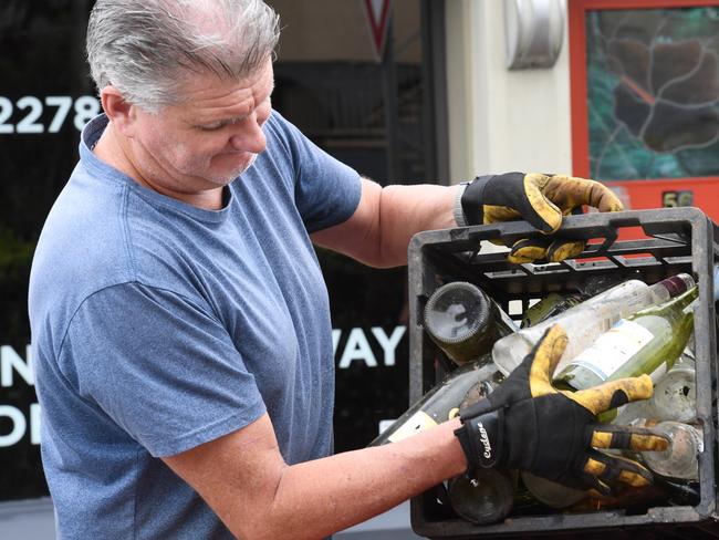 A Lismore businessman cleaning during the floods. Picture: Cath Piltz