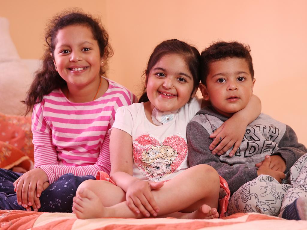 Alisha at home with her sister Aleena (left) and brother Avinash (right). Picture: Sam Ruttyn