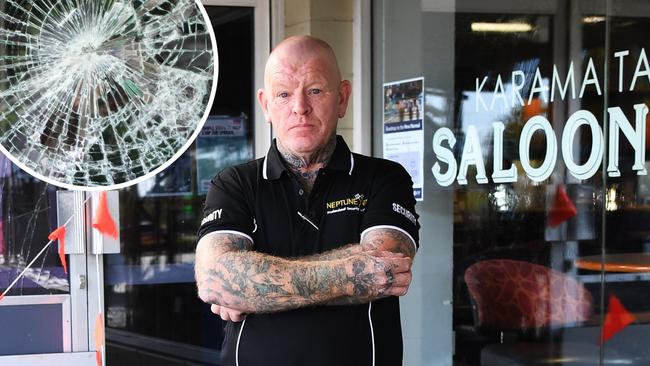 Neptune security guard Wayne Reed stands in front of damaged Karama Tavern. Picture: Katrina Bridgeford.