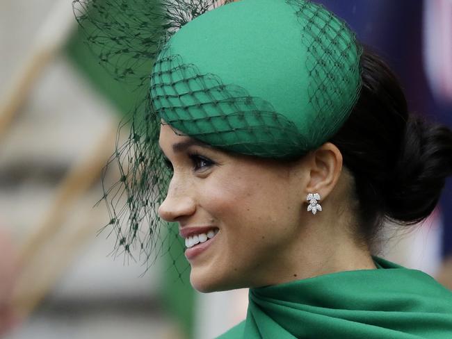 FILE - In this Monday, March 9, 2020 file photo, Britain's Meghan, the Duchess of Sussex receives flowers as she leaves after attending the annual Commonwealth Day service at Westminster Abbey in London. A preliminary hearing in the Duchess of Sussexâ€™s legal case against the Mail on Sunday and its parent company, Associated Newspapers, is set to take place in Britainâ€™s High Court on Friday April 24, 2020 as Meghan challenges the publication of a letter she wrote to her father, Thomas Markle. (AP Photo/Kirsty Wigglesworth, File)