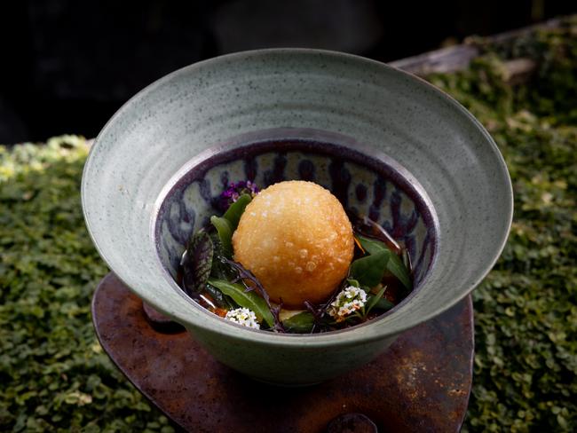 One of the Source’s Brioche Doughnut which features sweet corn custard, stracciatella, grilled baby corn, macadamia pesto, fragrant chili oil and brioche. Picture: Rosie Hastie/MONA