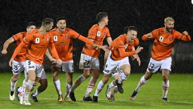 Brisbane Roar players celebrate their penalty shootout win.