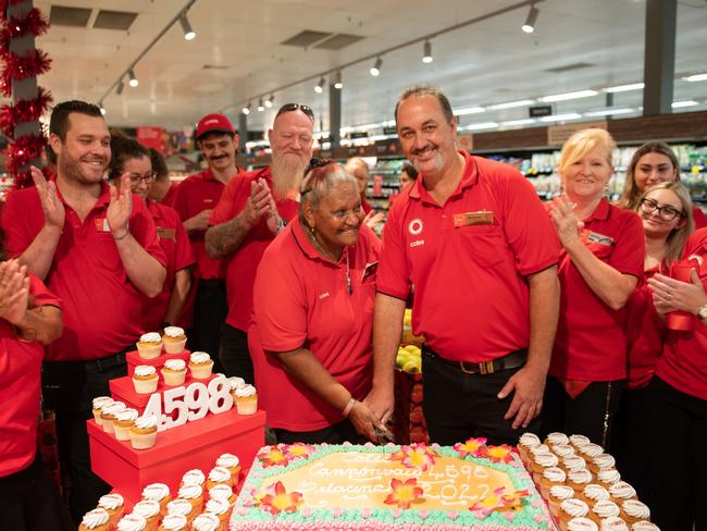 Cutting the cake at the Coles Cannonvale relaunch. Picture: Debbie Savy