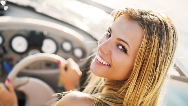 Cheerful young woman riding a speedboat. She is turning towards the camera. [url=http://www.istockphoto.com/search/lightbox/9786750][img]http://dl.dropbox.com/u/40117171/summer.jpg[/img][/url]