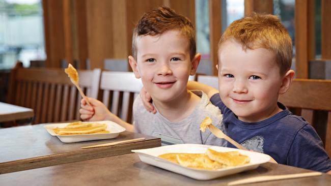 Jimmy Egan, 5, and Sean Egan, 3, were happy to embrace the new wooden cutlery at McDonalds. Picture: Adam Yip