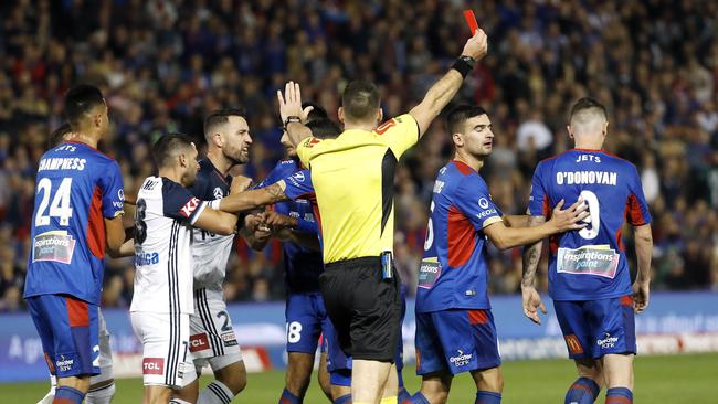 Fights break out after Newcastle Jets Roy O'Donovan attempts to kick the ball mid air but kicks Melbourne Victory's Lawrence Thomas in the head and receives a red card during the 2018 A-League Grand Final between Newcastle Jets and Melbourne Victory at McDonald Jones Stadium, Newcastle. Picture: Toby Zerna