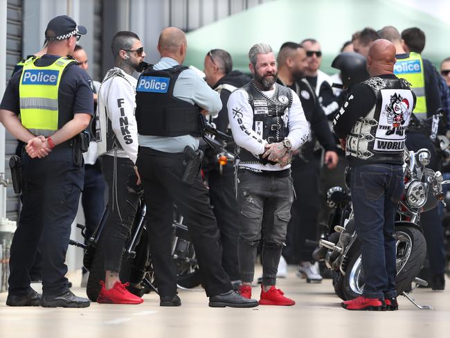 Police confront outlaw Finks bikies - including their leader Koshan Rashidi (right) - outside their clubhouse. Picture: David Crosling