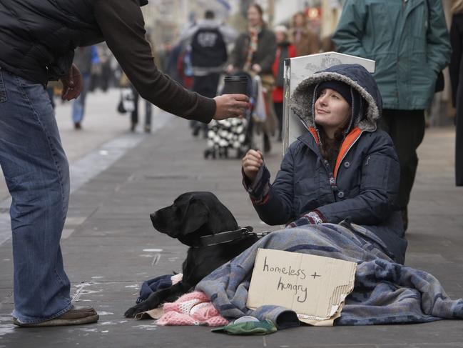 Generic poor picture by Thinkstock - Person giving cup to homeless woman.