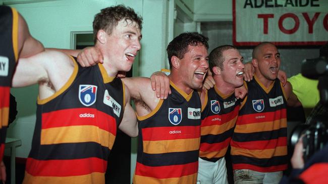 Troy Bond sings the song with teammates Simon Goodwin, Kym Koster and Andrew McLeod in 1997.