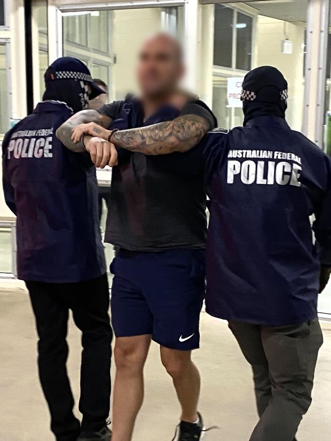 Mark Buddle being escorted through Darwin airport. Picture: AFP