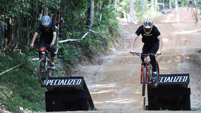 Aim Hocking and Chad Smith hit the jump simultaneously in the U19 Men’s Dual Slalom quarter finals at the first day of the Cairns round of the Crankworx World Tour, held at the Smithfield Mountain Bike Park. Picture: Brendan Radke