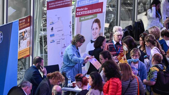 Refugees from Ukraine line up for information at a booth at a job fair organised by the Chamber of Industry and Commerce in Berlin.Picture: AFP.