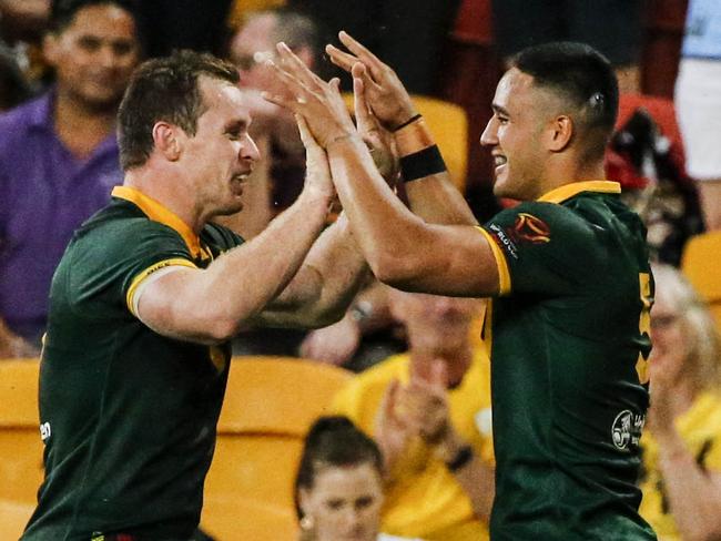 Valentine Holmes (right) of the Kangaroos celebrates with Michael Morgan of the Kangaroos after scoring his 6th try in a single World Cup match during the Rugby League World Cup semi-final between Australia and Fiji at Suncorp Stadium in Brisbane, Saturday, November 24, 2017. (AAP Image/Glenn Hunt) NO ARCHIVING, EDITORIAL USE ONLY