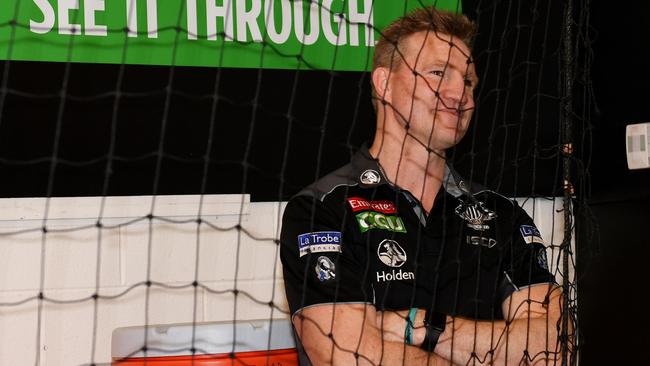 Magpies head coach Nathan Buckley watches the team celebrate after their win. (AAP Image/Tracey Nearmy)